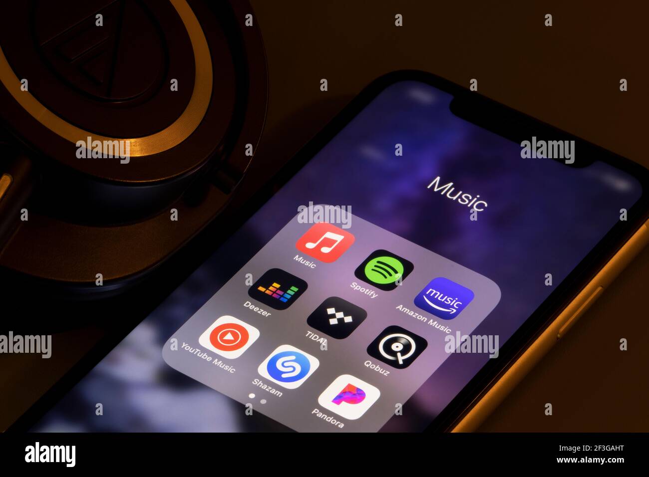 Assorted music apps - Apple Music, Spotify, Amazon Music, Deezer, TIDAL, Qobuz, YouTube Music, Shazam, and Pandora - are seen on an iPhone. Stock Photo