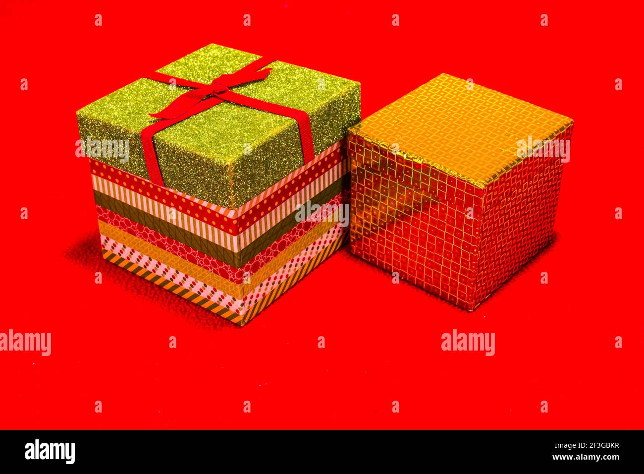 Two Christmas Gift Boxes On Red Background Stock Photo