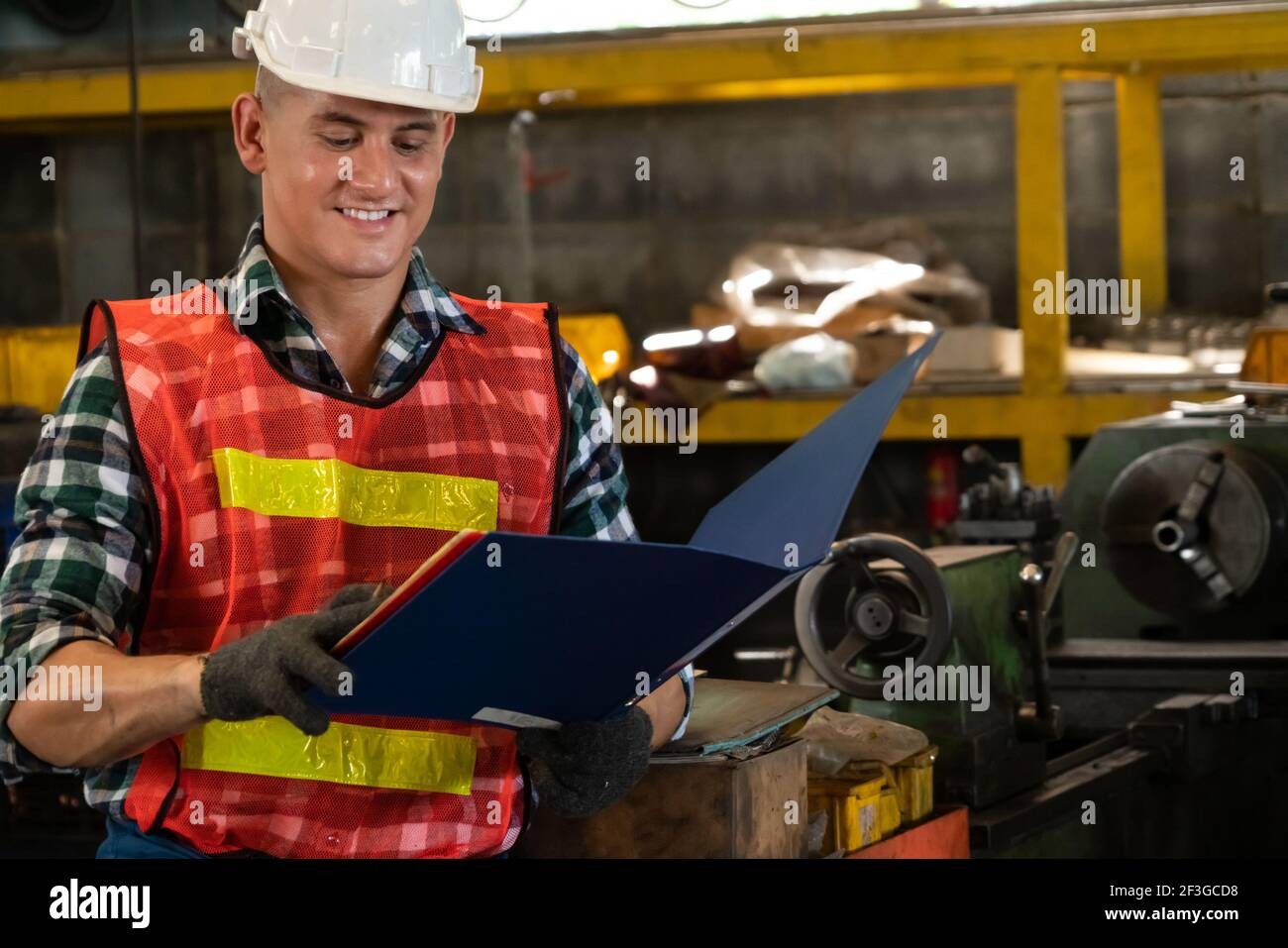 Manufacturing worker working with clipboard to do job procedure