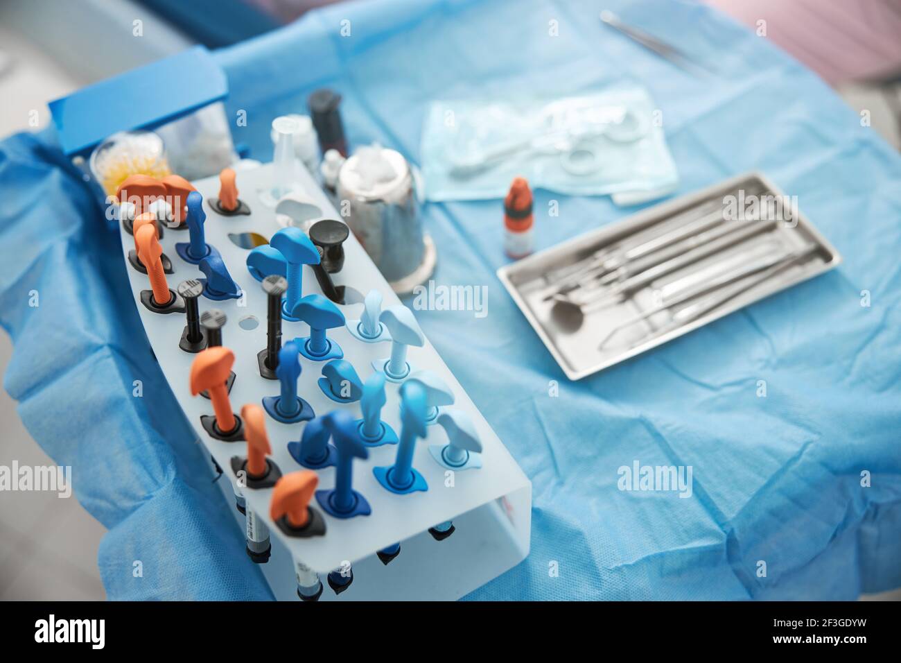 Table with dental composite resins stand near instrument tray Stock Photo
