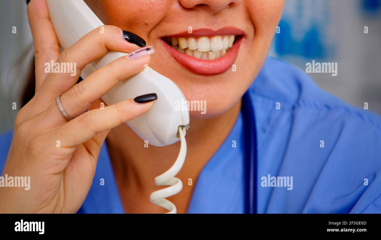 Close up of specialist practitioner talking at phone during telehealth communication, helping patient with mild health conditions. Healthcare physician in uniform, doctor assistant offering consultation Stock Photo