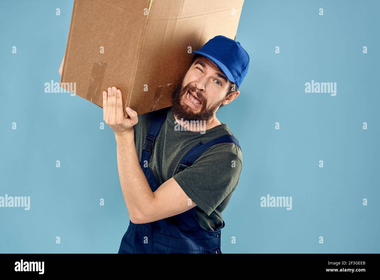 Man in working uniform loading service and delivery blue background ...