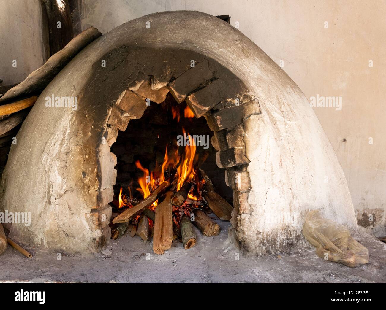A selective focus of burning firewoods inside an old brick fireplace Stock Photo