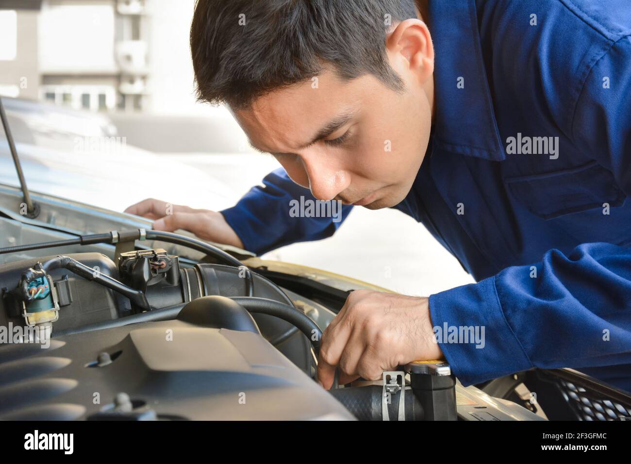Auto mechanic checking car engine Stock Photo