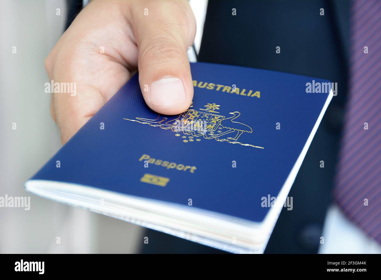 Hands giving passport (of Australia) Stock Photo