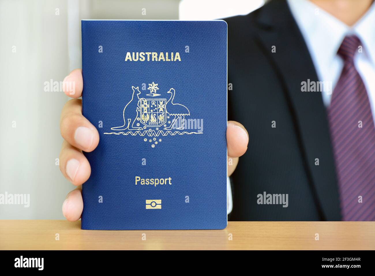 Businessman showing passport (of Australia) Stock Photo