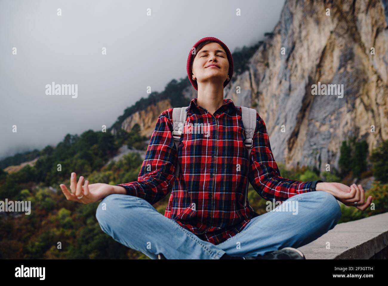 Asian hipster woman walking alone on a mountain highway on an autumn ...