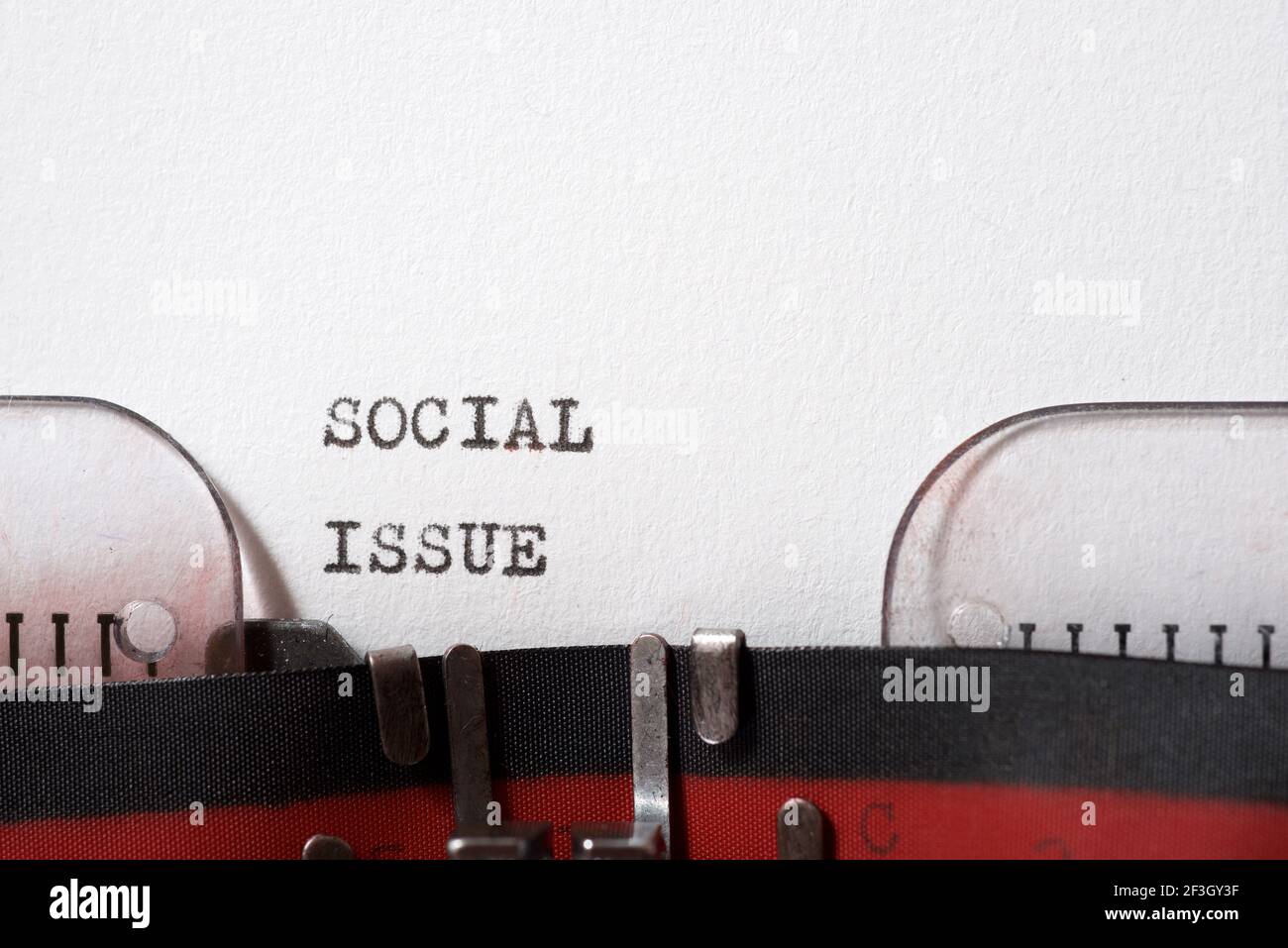Social issue phrase written with a typewriter Stock Photo - Alamy