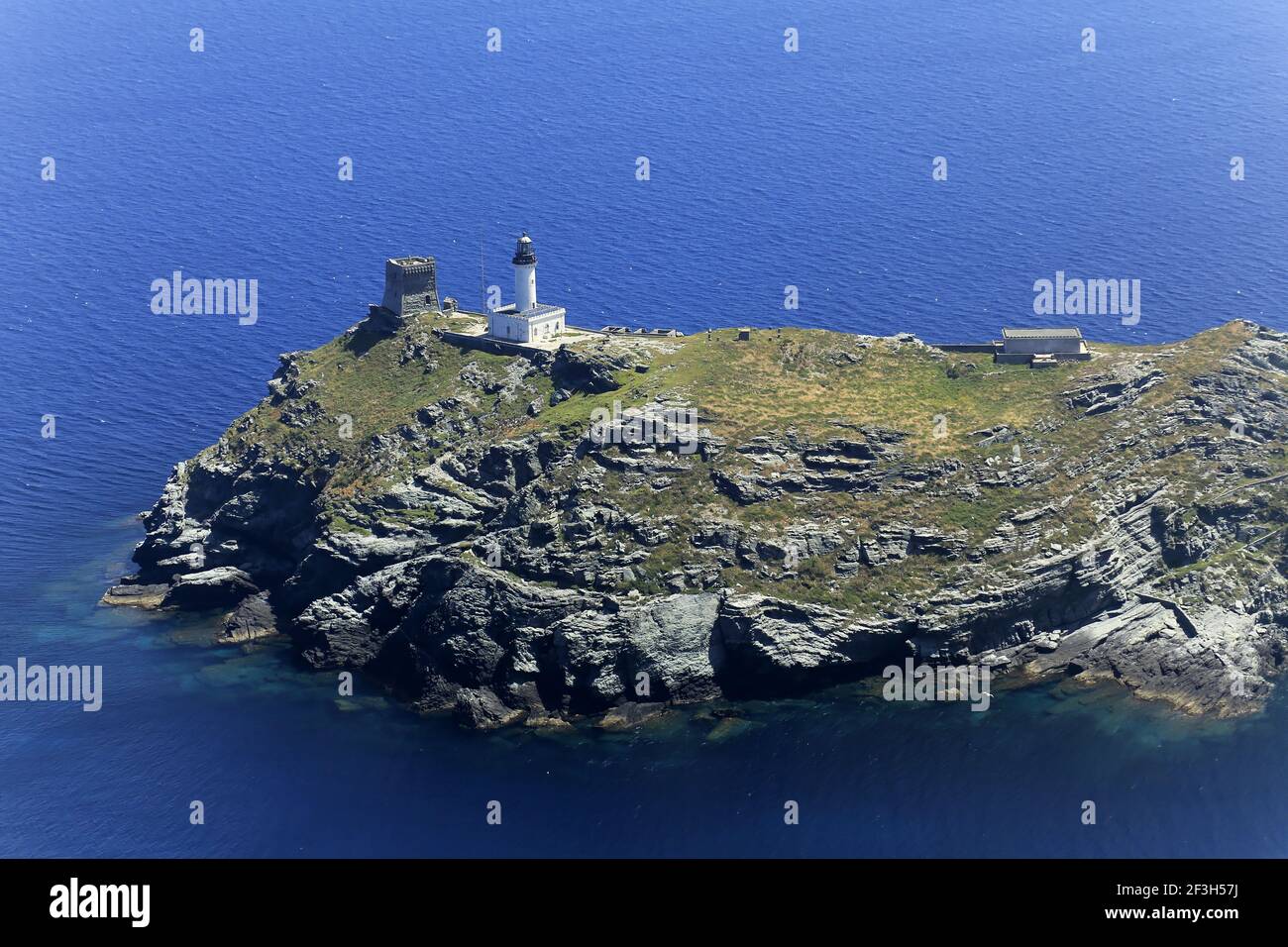 Department of Corse-du-Sud, Southern Corsica: aerial view of Giraglia Island with its lighthouse and a Genoese tower dating back to the 16th century, Stock Photo