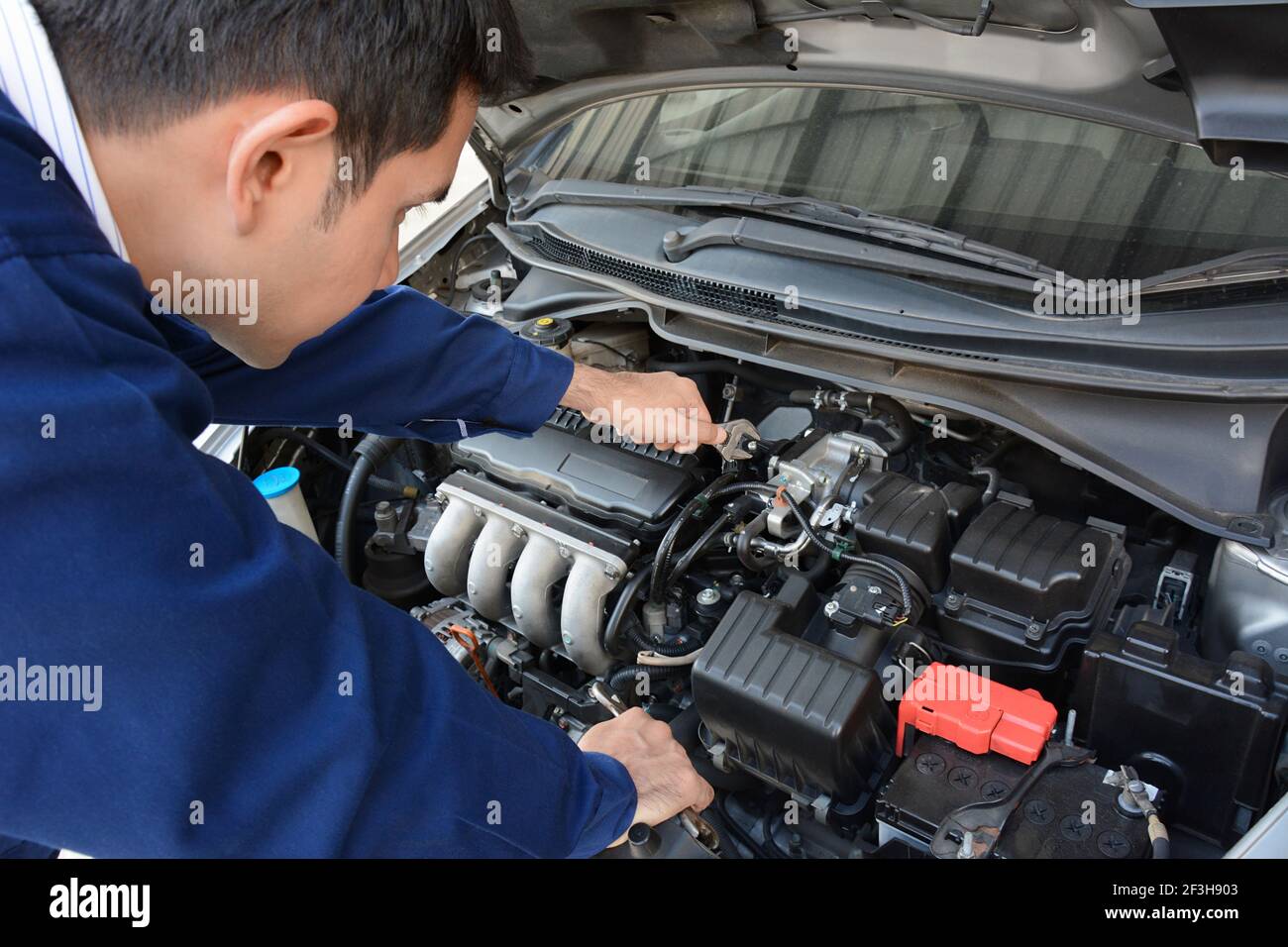 Auto mechanic (or technician) fixing car engine Stock Photo