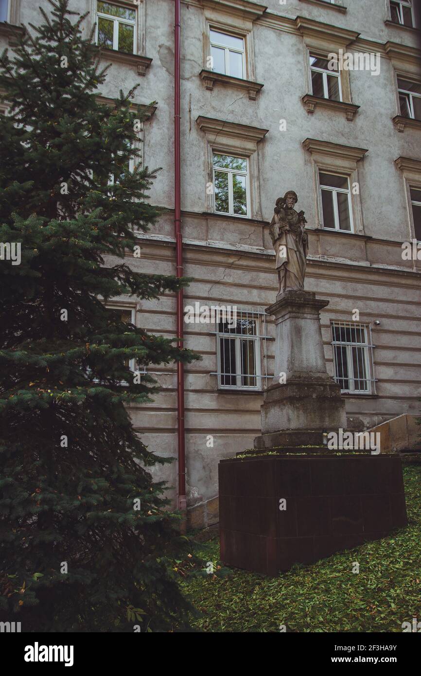 Old statue in front of The Higher Theological Seminary in Przemysl Stock Photo