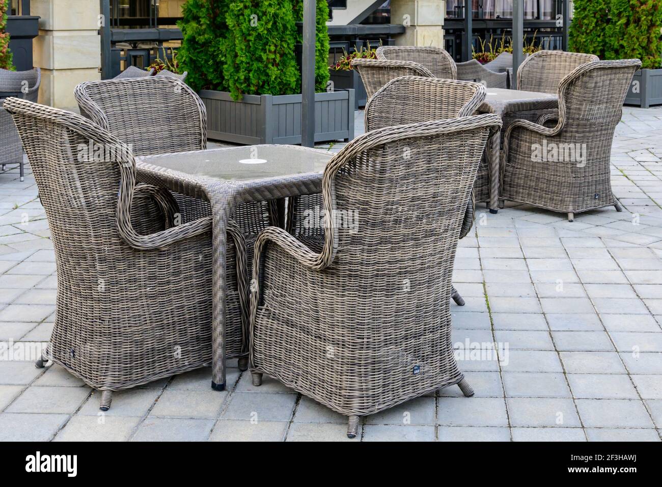 Outdoor veranda with wicker chairs and tables Stock Photo Alamy