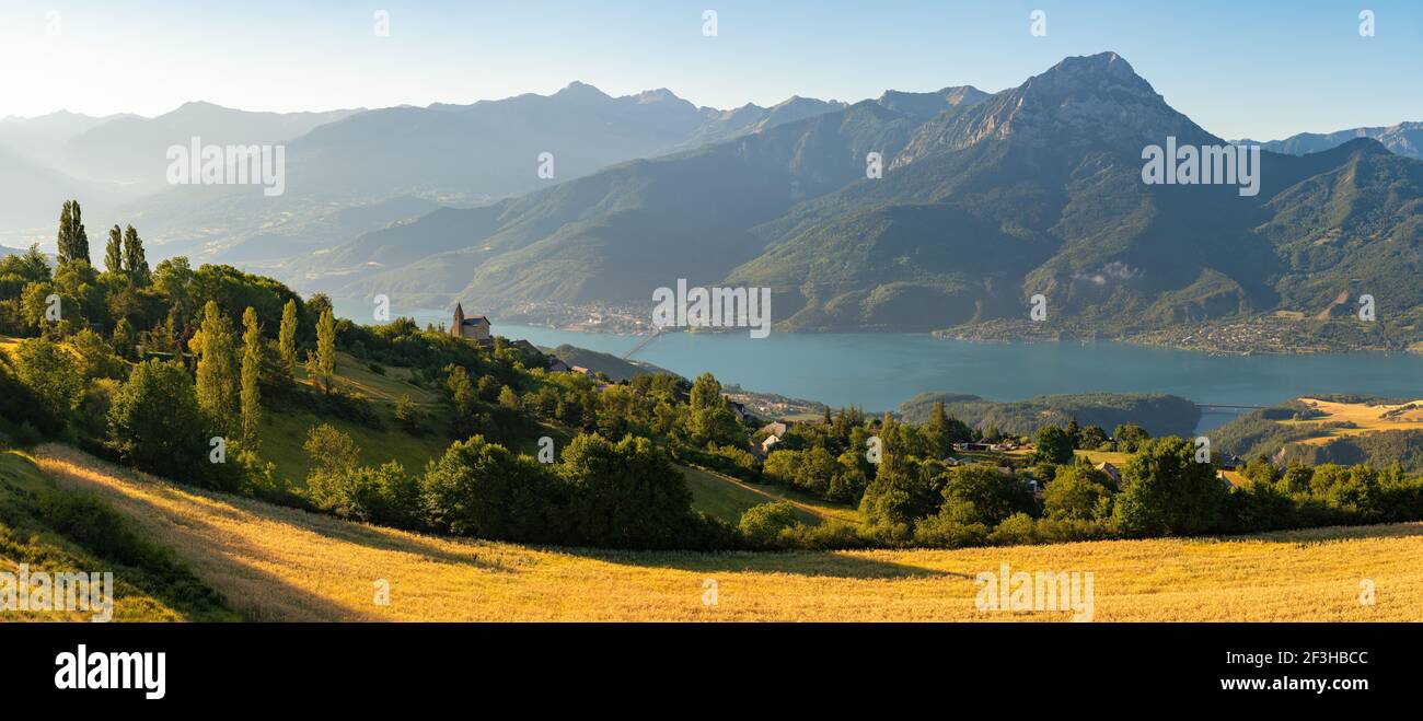 Serre-Poncon Lake in summer with Grand Morgon Peak and Savines-le-Lac village. Hautes-Alpes, Alps, France Stock Photo