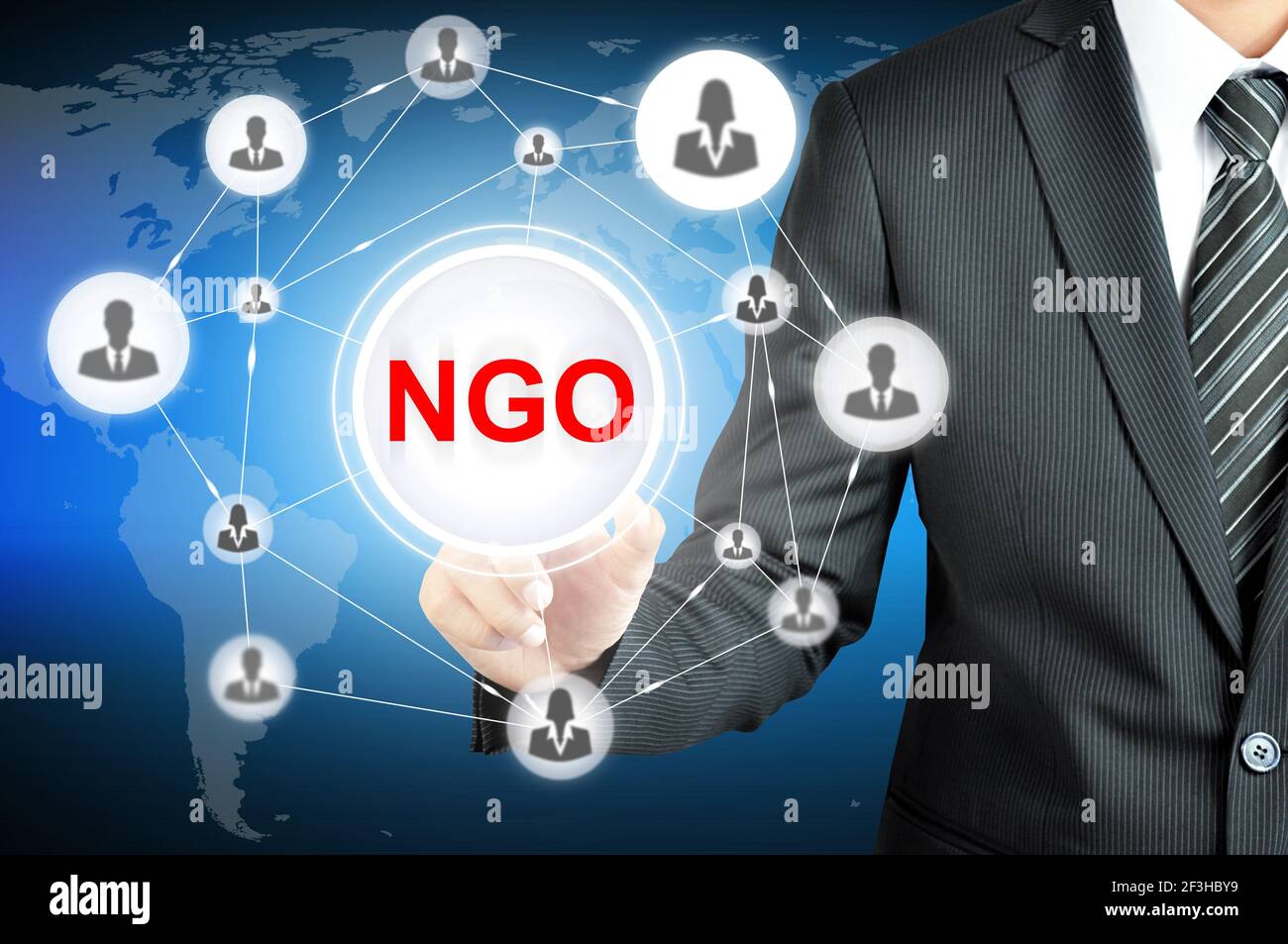 Businessman pointing on NGO (Non-Governmental Organization) sign on virtual screen with people icons linked as network Stock Photo