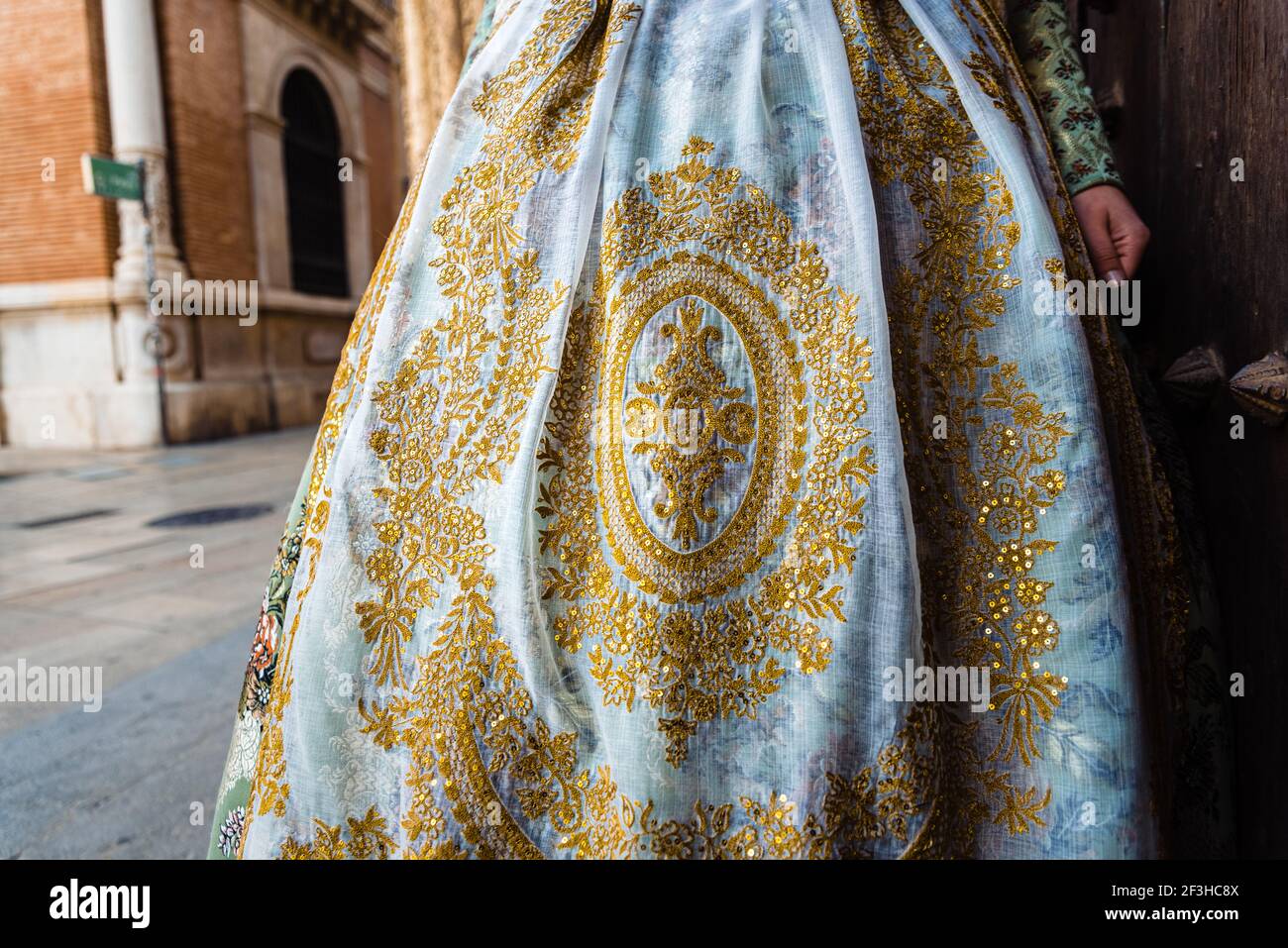 Detail of the traditional fallera dress with rich golden thread embroidery on a silk skirt Stock Photo Alamy