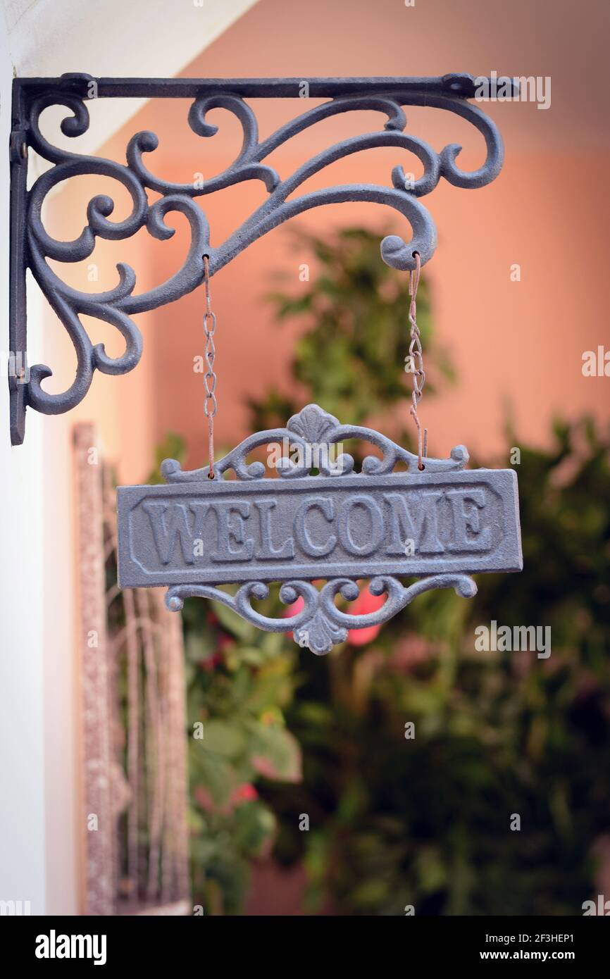 Welcome sign hanging on the wall Stock Photo