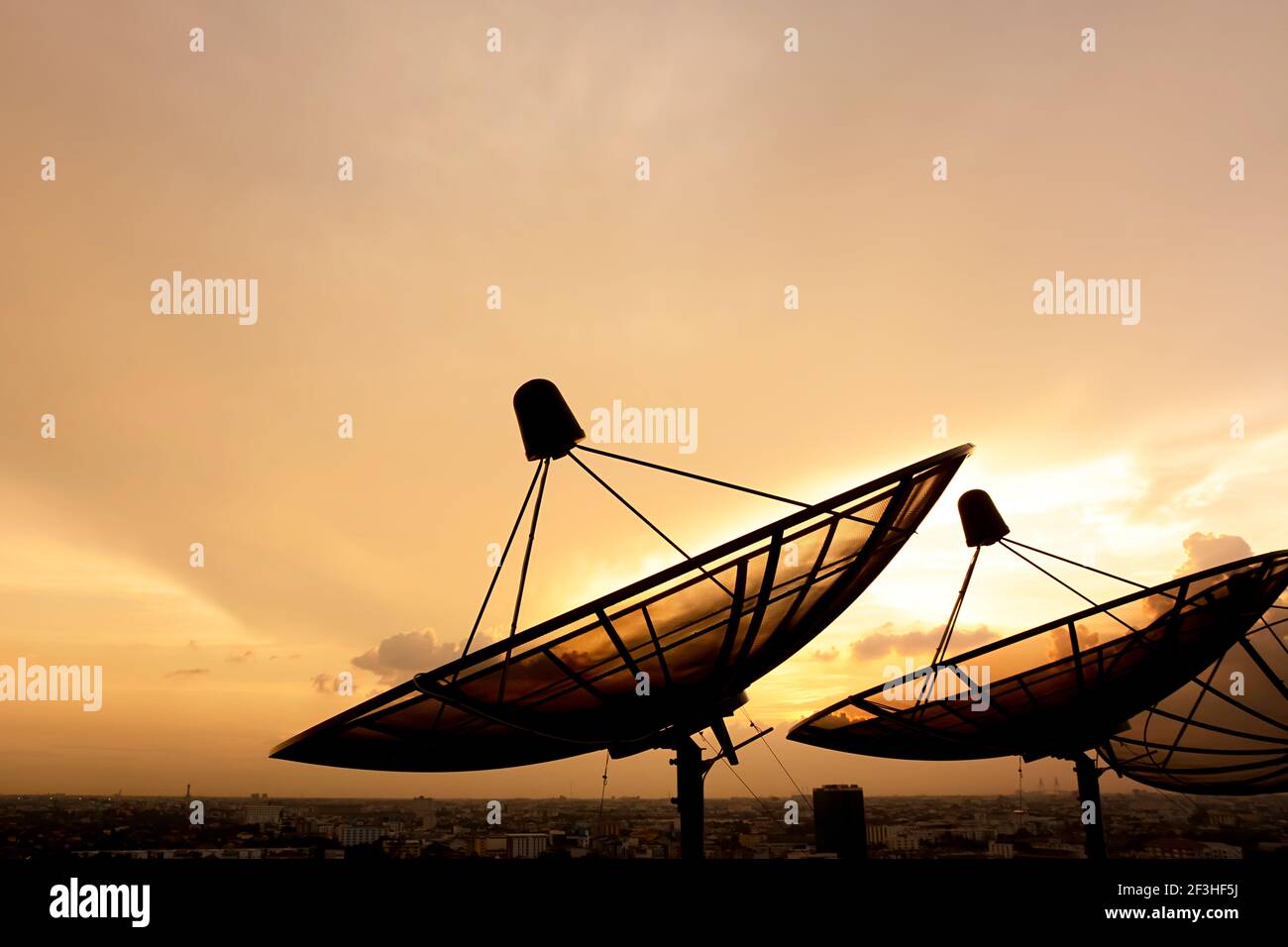 Satellite dish silhouette on twilight sky background Stock Photo