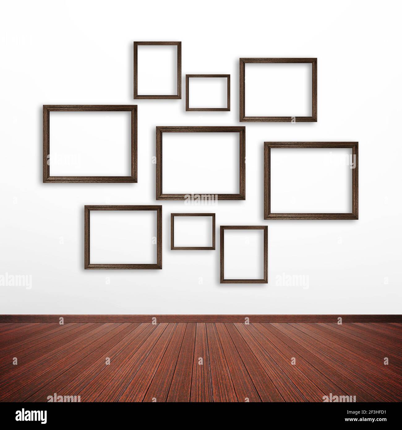 Wooden picture frames on white wall inside the room Stock Photo
