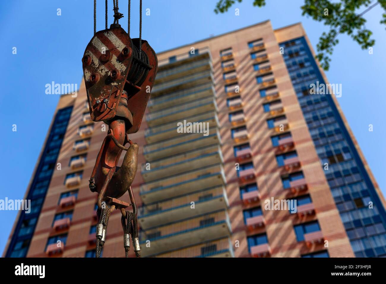 Construction crane hook with multi-storey building under construction ...