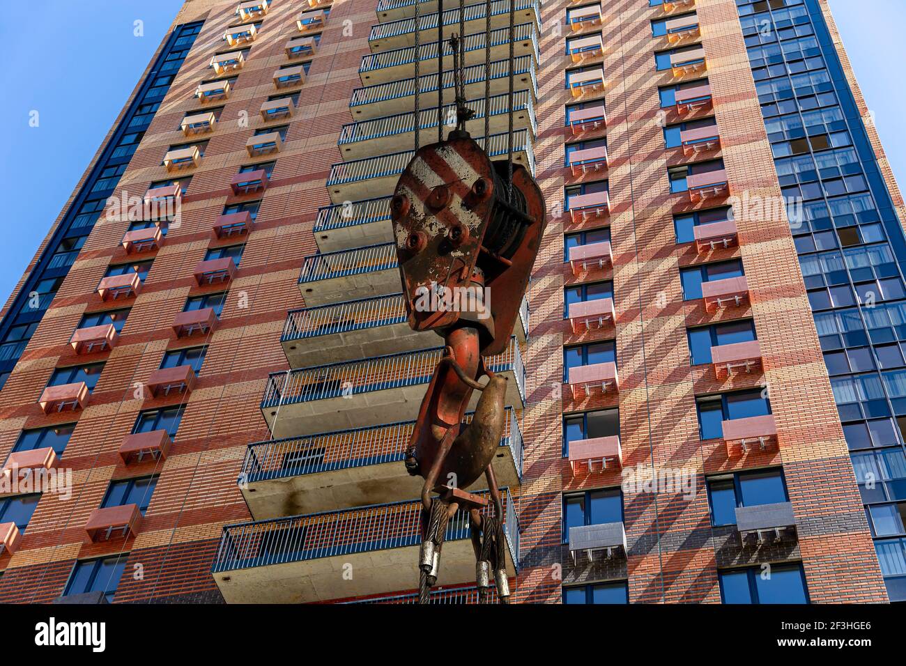 Construction crane hook with multi-storey building under construction ...