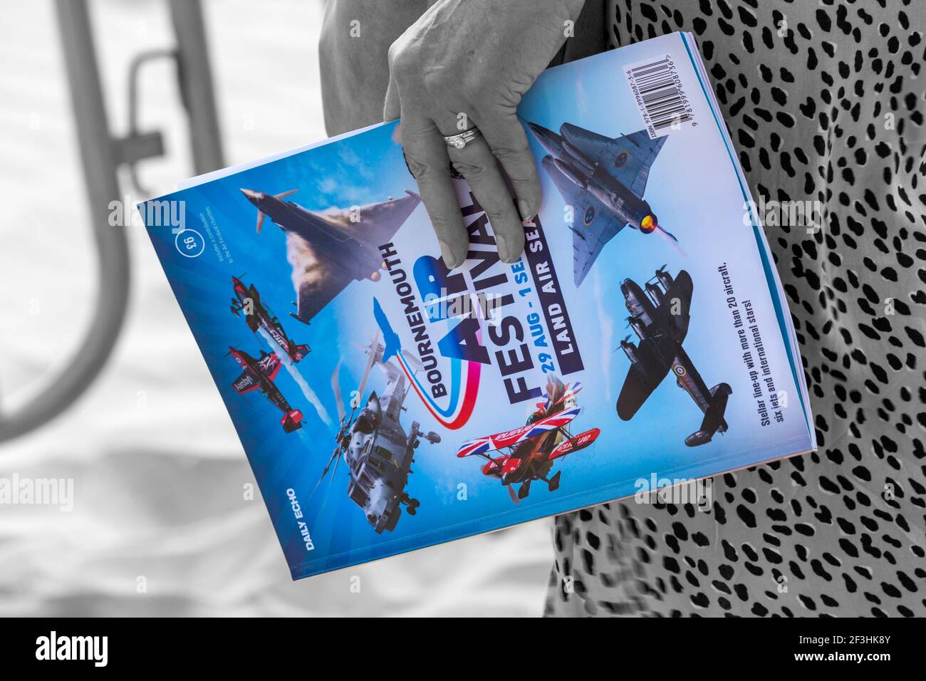 Woman holding Bournemouth Air Festival programme at Bournemouth Air Festival, Bournemouth, Dorset UK in August Stock Photo
