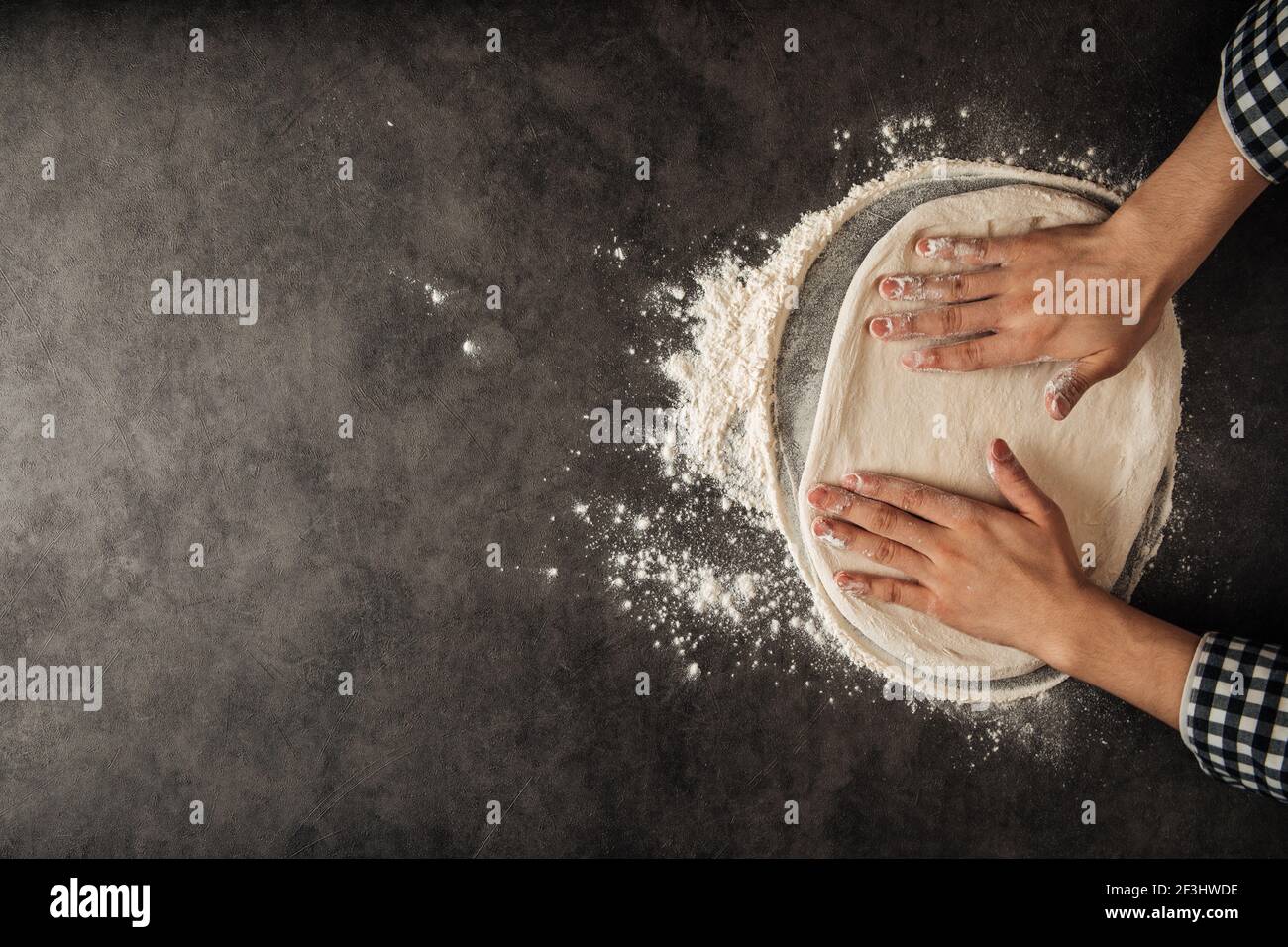 Hands making a pizza dough with flour Stock Photo - Alamy