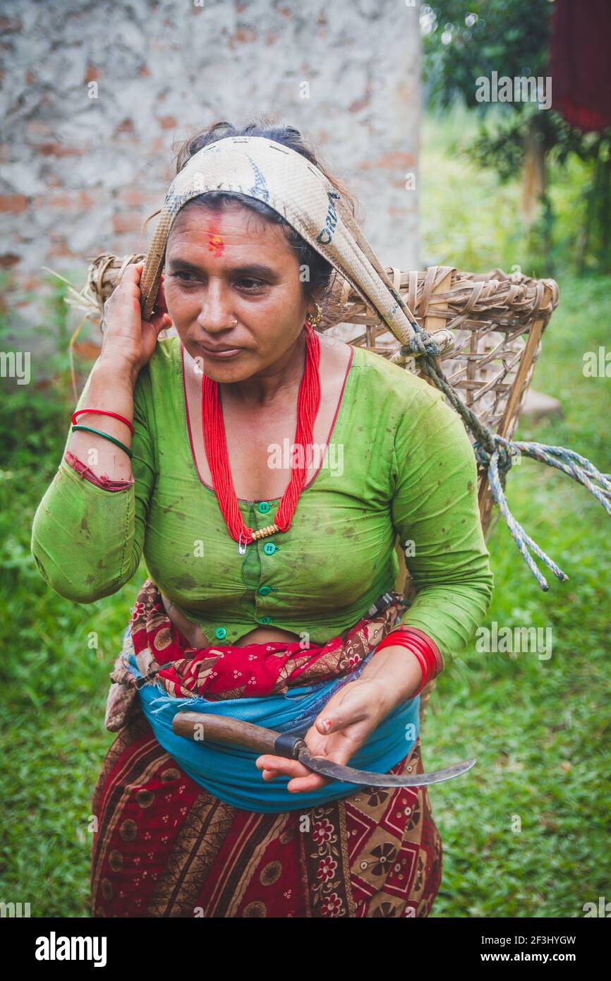 Nepali Village Woman Carrying Basket In Traditional Style In The Rural