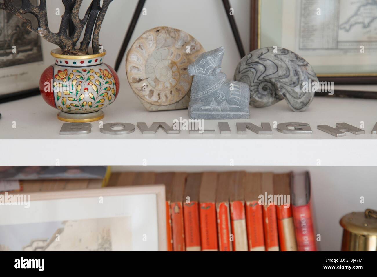 Antiques on bookshelves | Architect: Silk Mews Architects | Stock Photo
