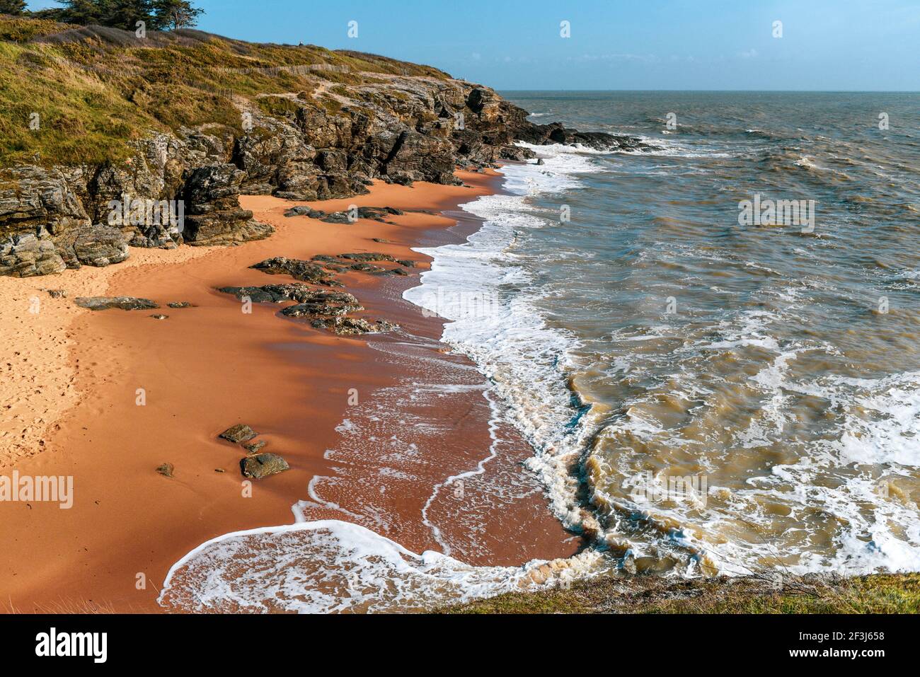 Rocky sandy coast of France on a sunny day, beautiful sea landscape. Stock Photo