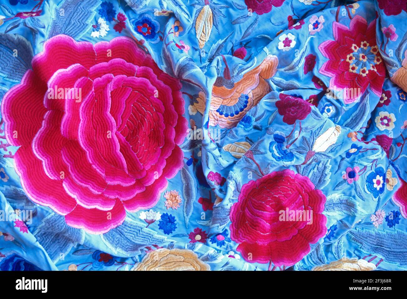 A blue export shawl of plum blossoms (symbolising beauty and long life), is an example of a decorative Chinoiserie piece, Hong Kong, China. Stock Photo
