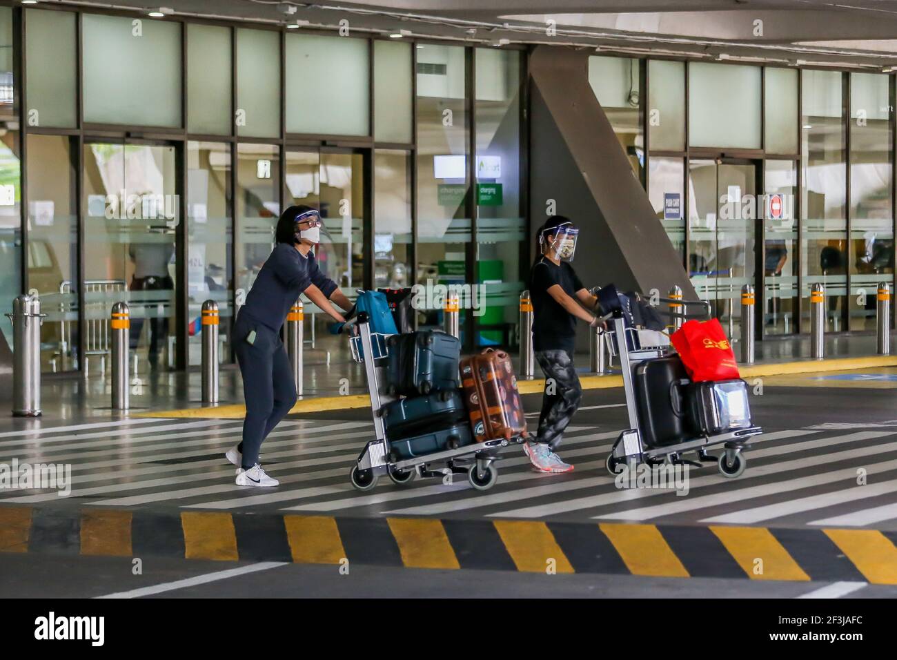 (210317) -- MANILA, March 17, 2021 (Xinhua) -- Arriving passengers wearing protective shields are seen inside the Terminal 1 of the Ninoy Aquino International Airport in Manila, the Philippines, on March 17, 2021. The Philippines said it will temporarily suspend the entry of foreigners and some citizens as the Southeast Asian country battles a renewed spike in COVID-19 cases. In a statement issued on Tuesday night, the country's coronavirus task force said foreign citizens and returning nationals who had not been working overseas will not be able to enter the country from March 20 until April Stock Photo