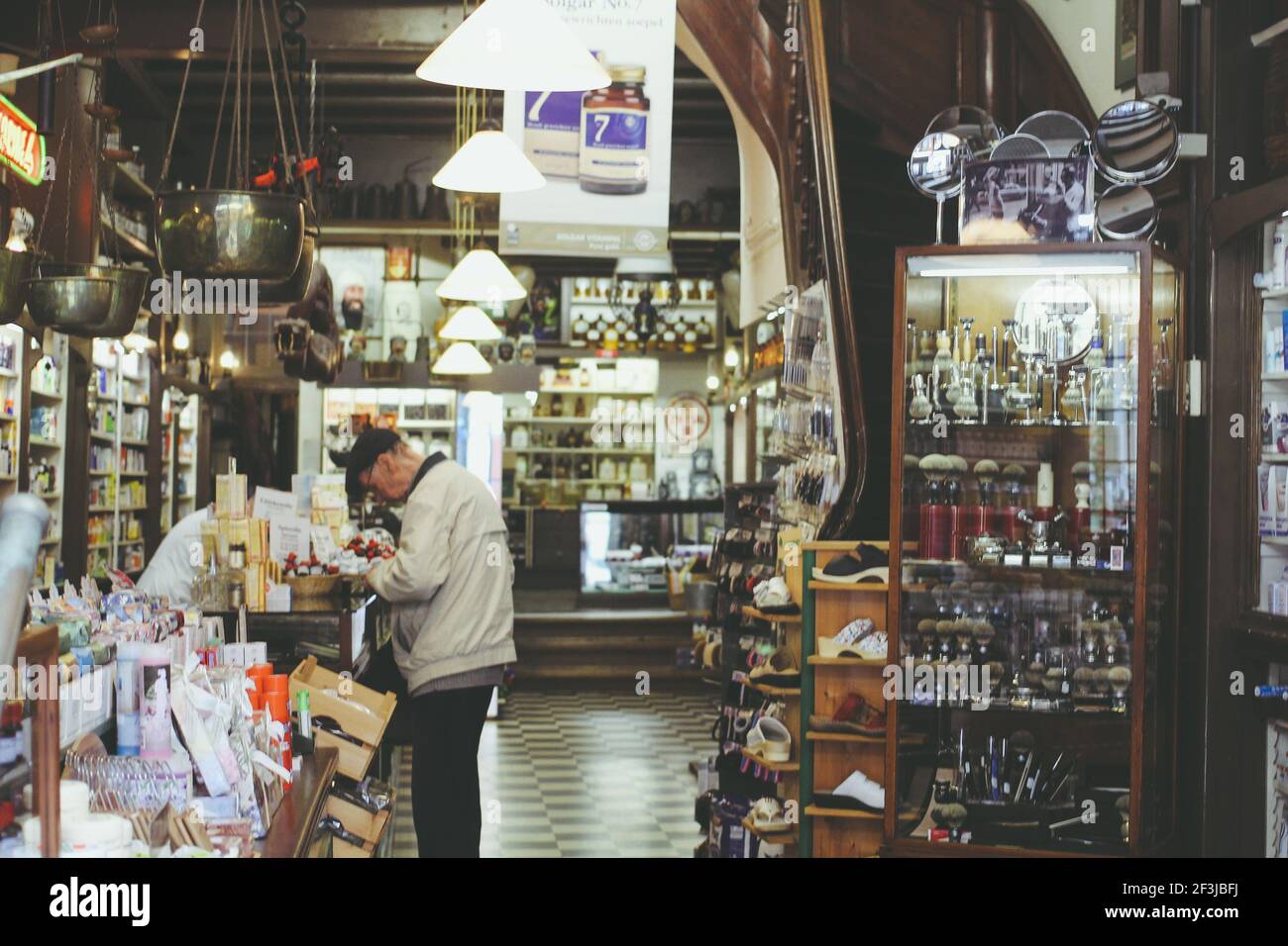 AMSTERDAM, NETHERLANDS - Jun 28, 2014: A horizontal shot of the customer buying medicine products in retro vintage pharmacy in Amsterdam, the Netherla Stock Photo