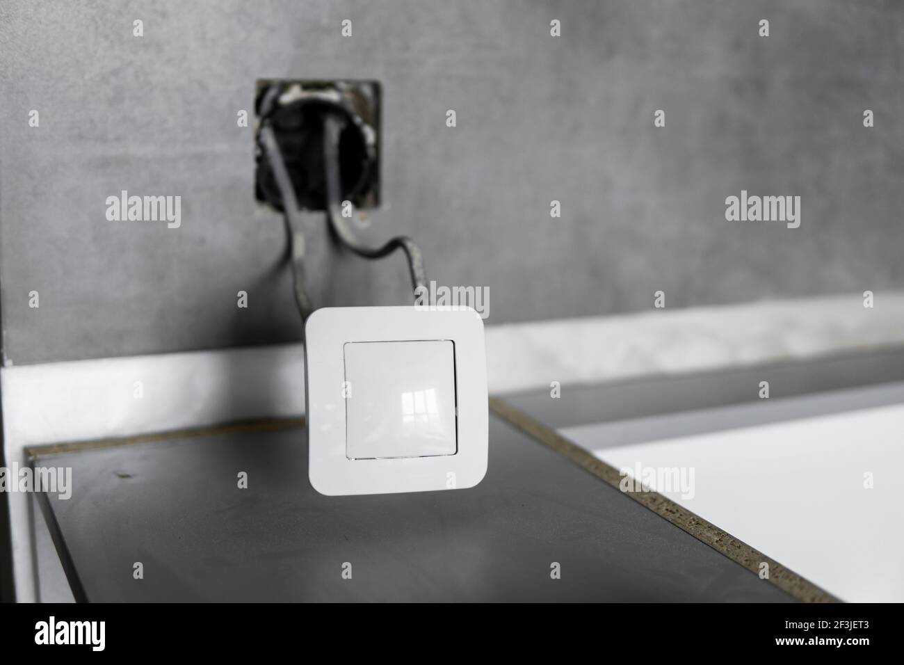 Repair or installation of a new light switch in the wall. Light switch