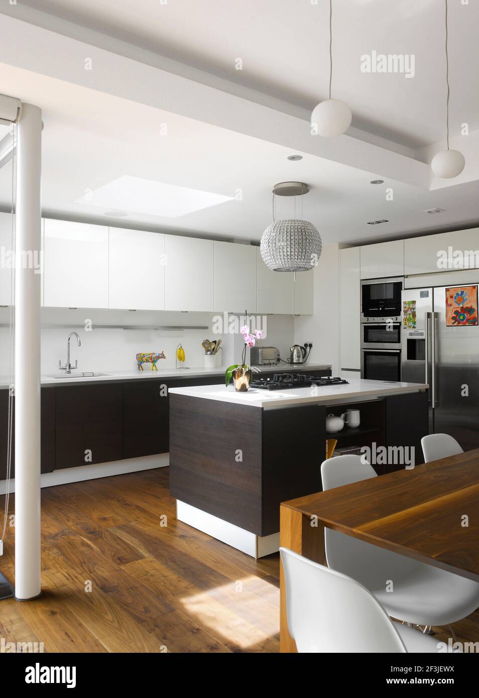 Modern kitchen with island unit and white fitted units Stock Photo