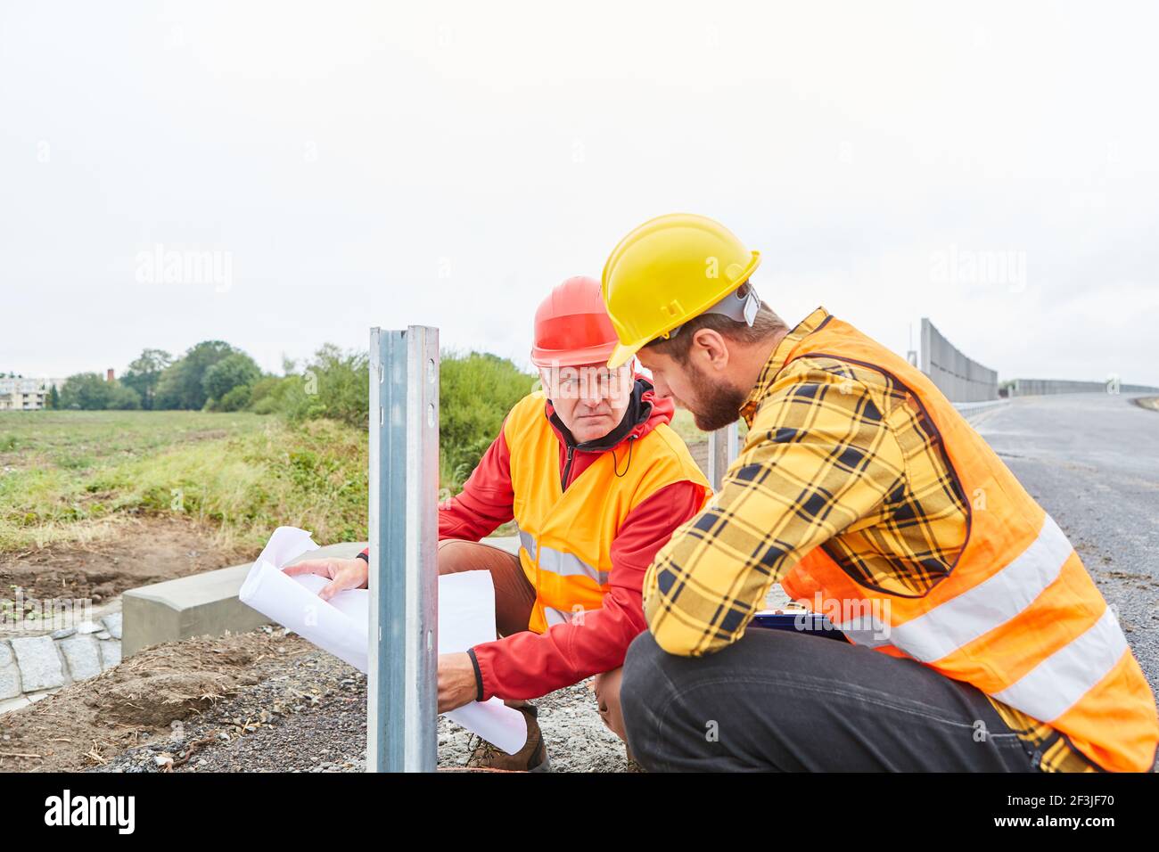 The architect and foreman check the foundations and construction of the guard rails Stock Photo