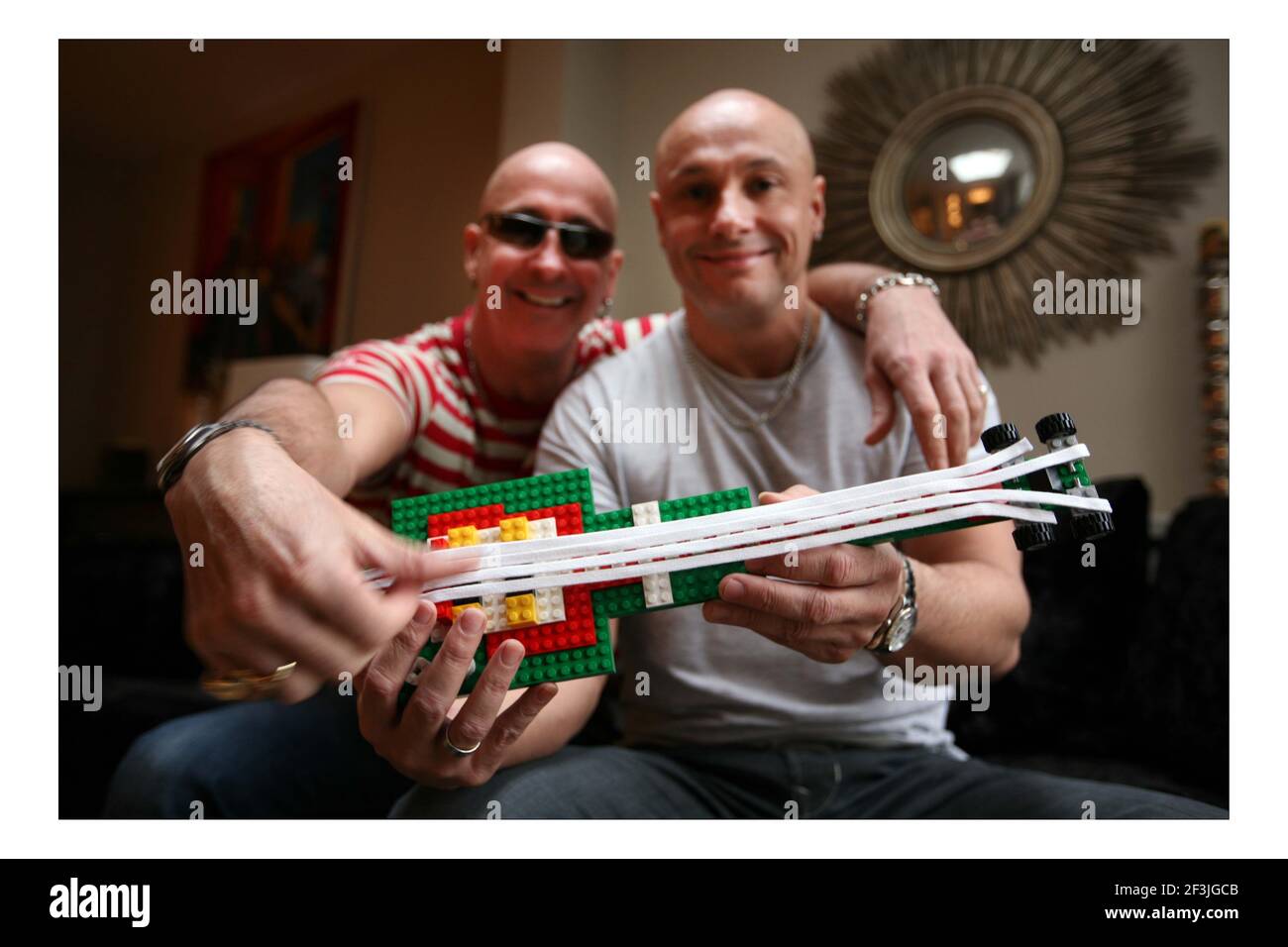 LEGO..... 'Right Said Fred' Fred (grey T shirt) and Richard (red stripe T shirt)  Fairbrass with their LEGO guitar at home in west London  pic David Sandison Stock Photo