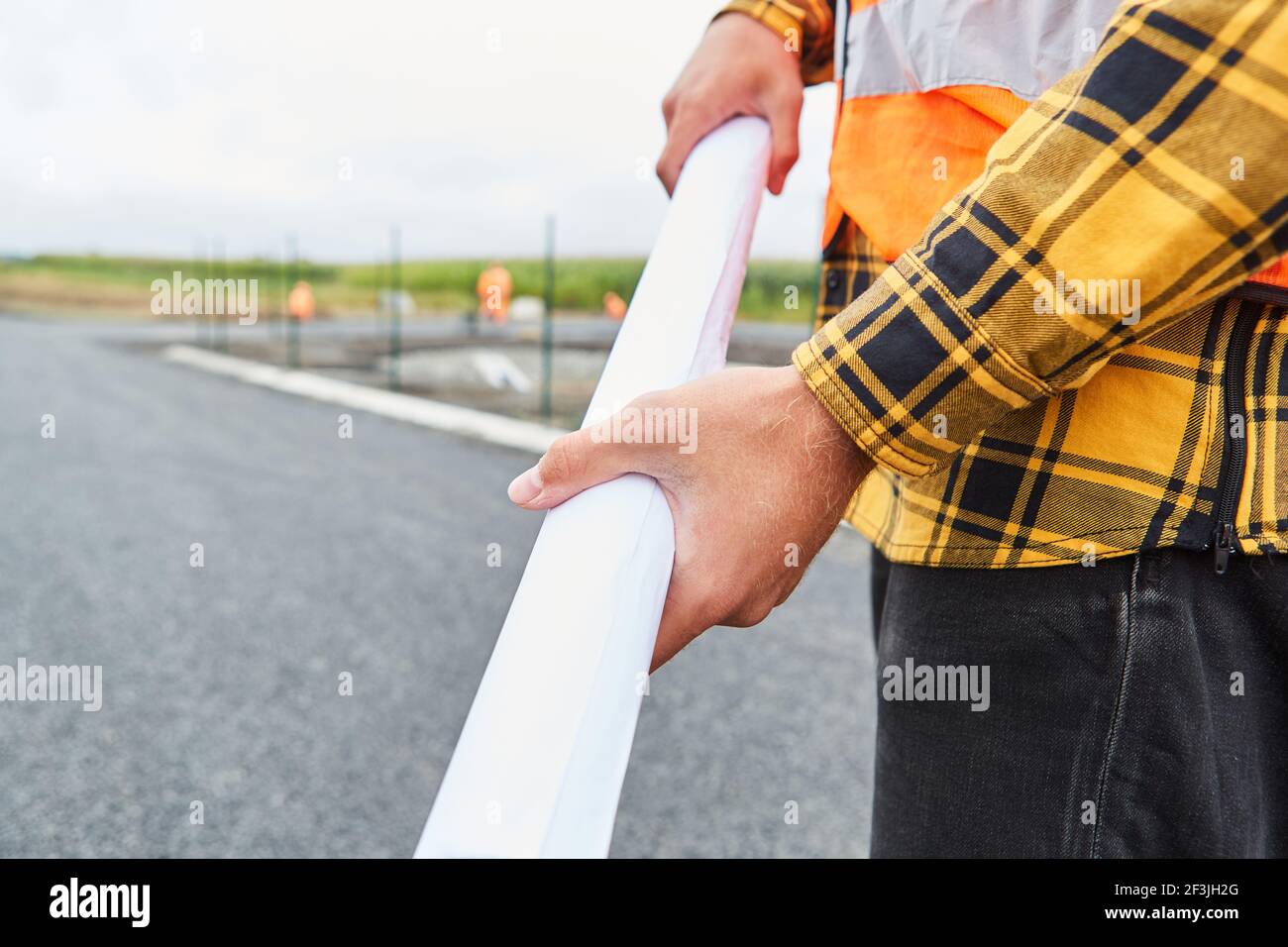Construction worker with development plan or site plan on the construction site of road construction Stock Photo