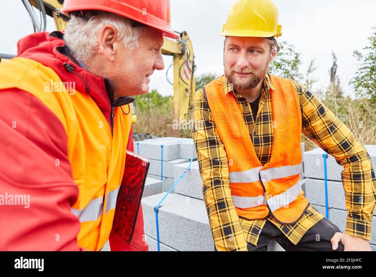 Construction workers and site managers in a meeting on the construction site of building a house Stock Photo