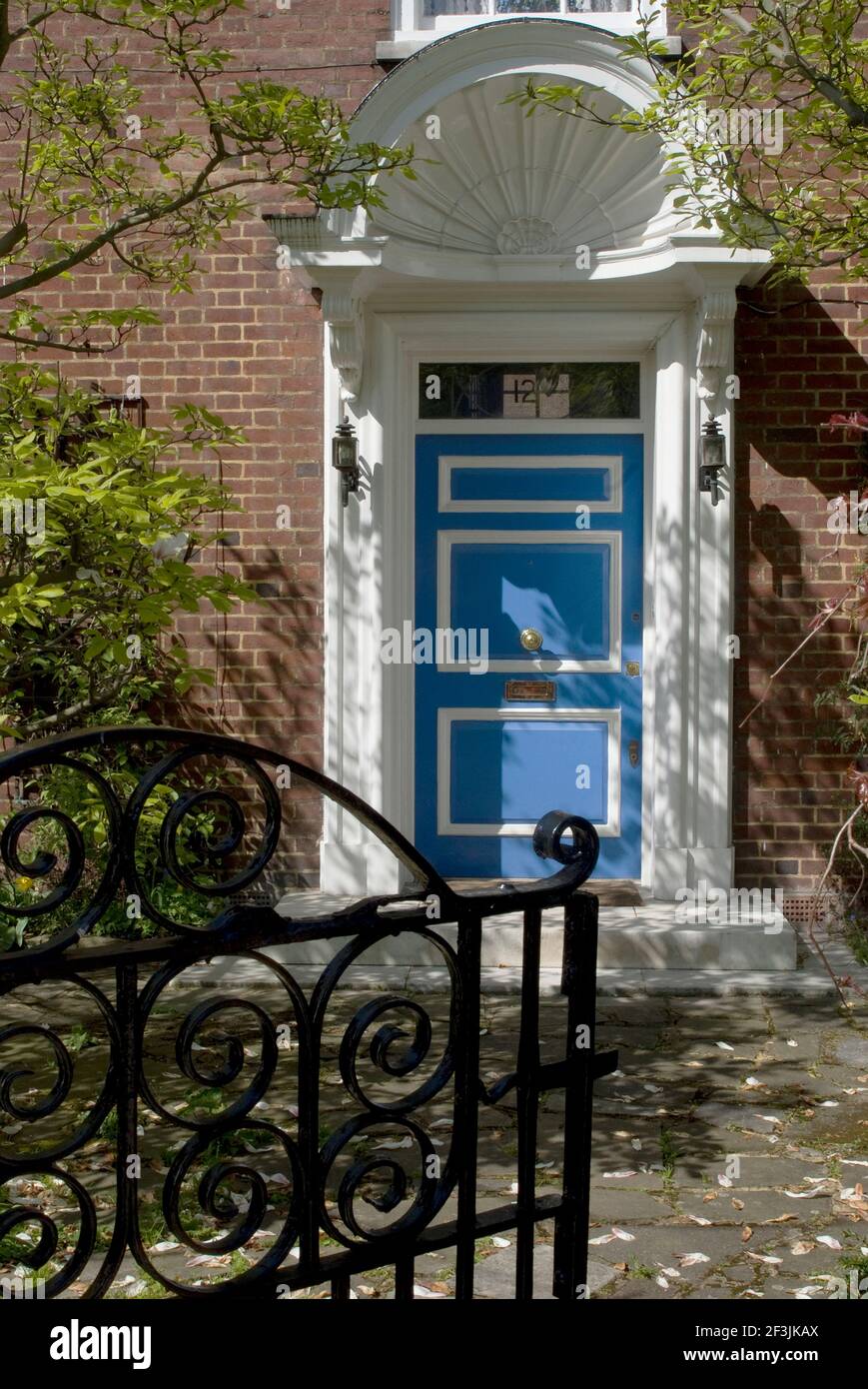 Entrance door with an elaborate archivolt to a large house with iron gate, St John's Wood