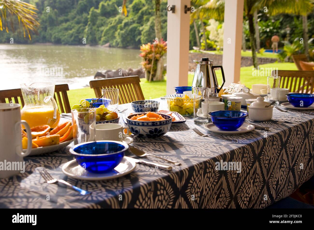Private home in Parati Brazil. Back terrace, overlooking the sea, with the table set for breakfast. Stock Photo