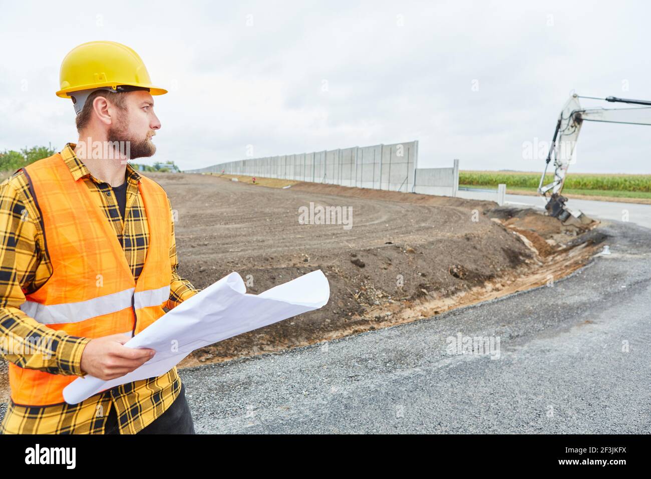 Working Construction Route Construction workers in road construction with a site plan on the ...