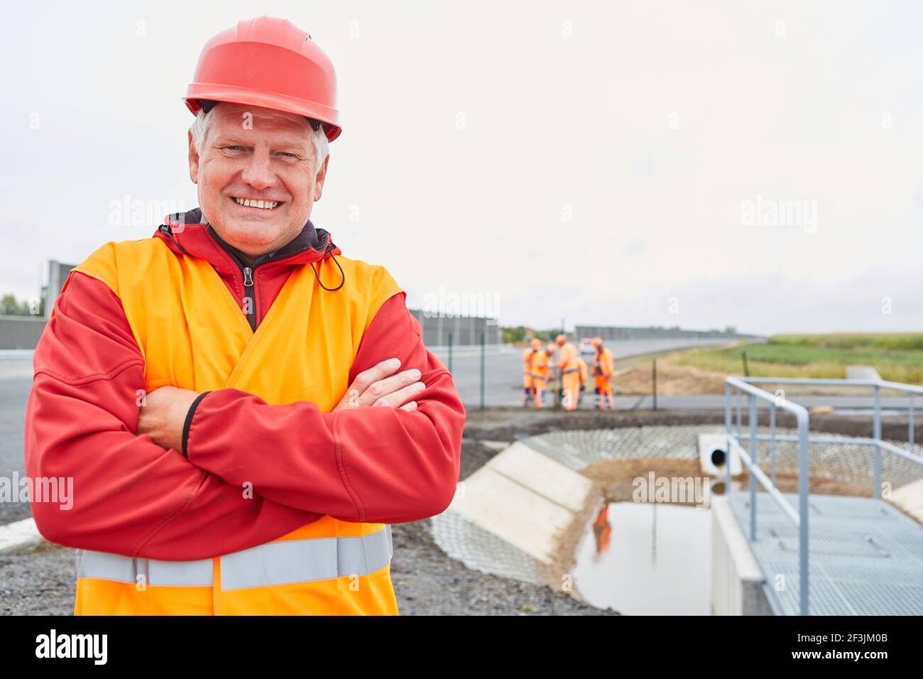 Proud architect or foreman on a road construction site in the new development area Stock Photo