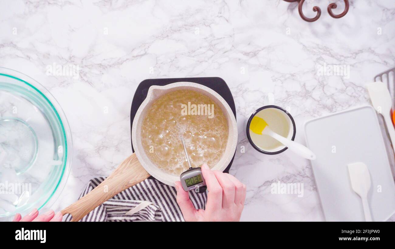 Flat lay. Step by step. Caramelizing sugar in a small cooking pot over ...
