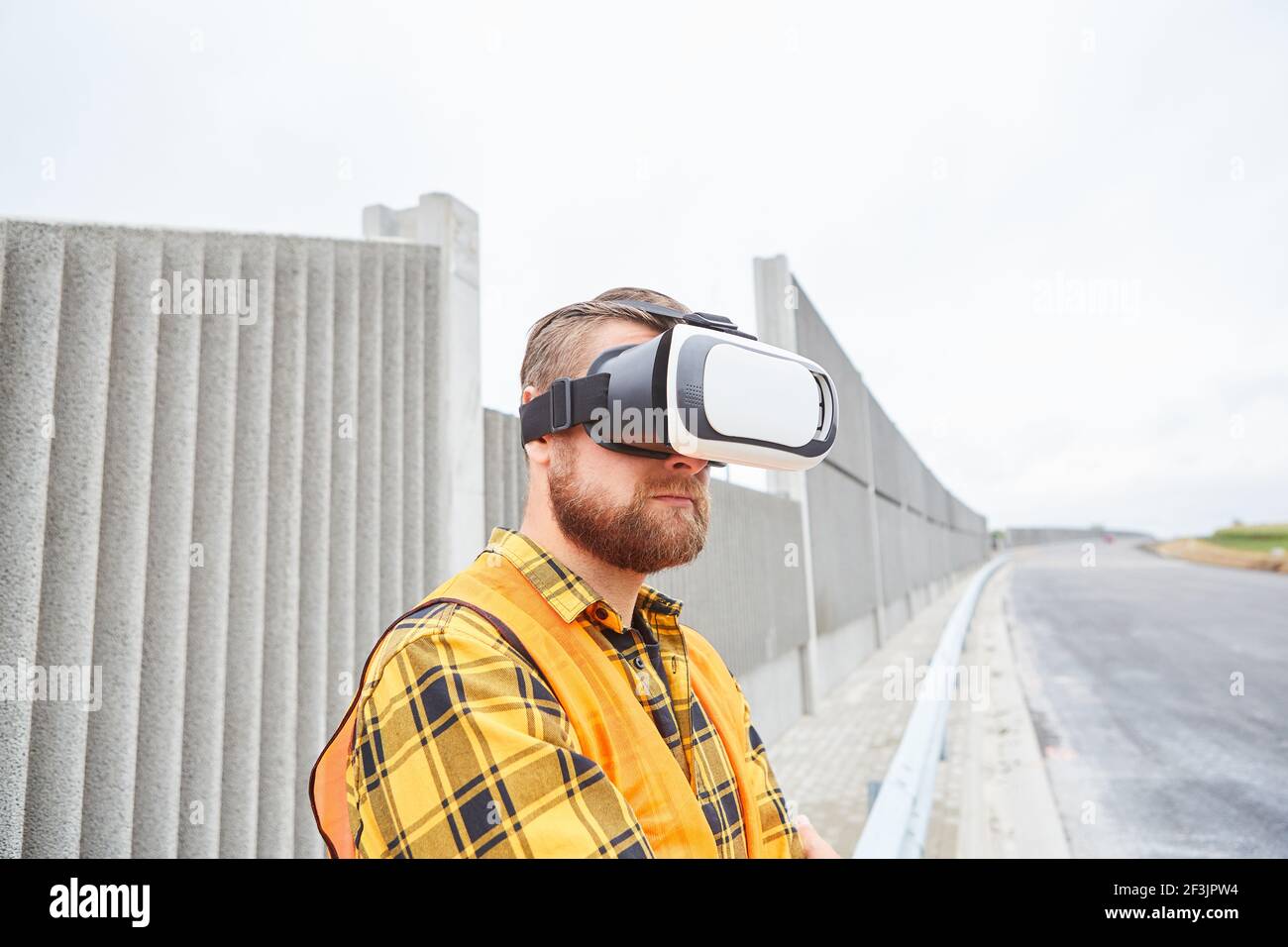 Worker with virtual reality glasses for road construction planning the future in cyberspace Stock Photo