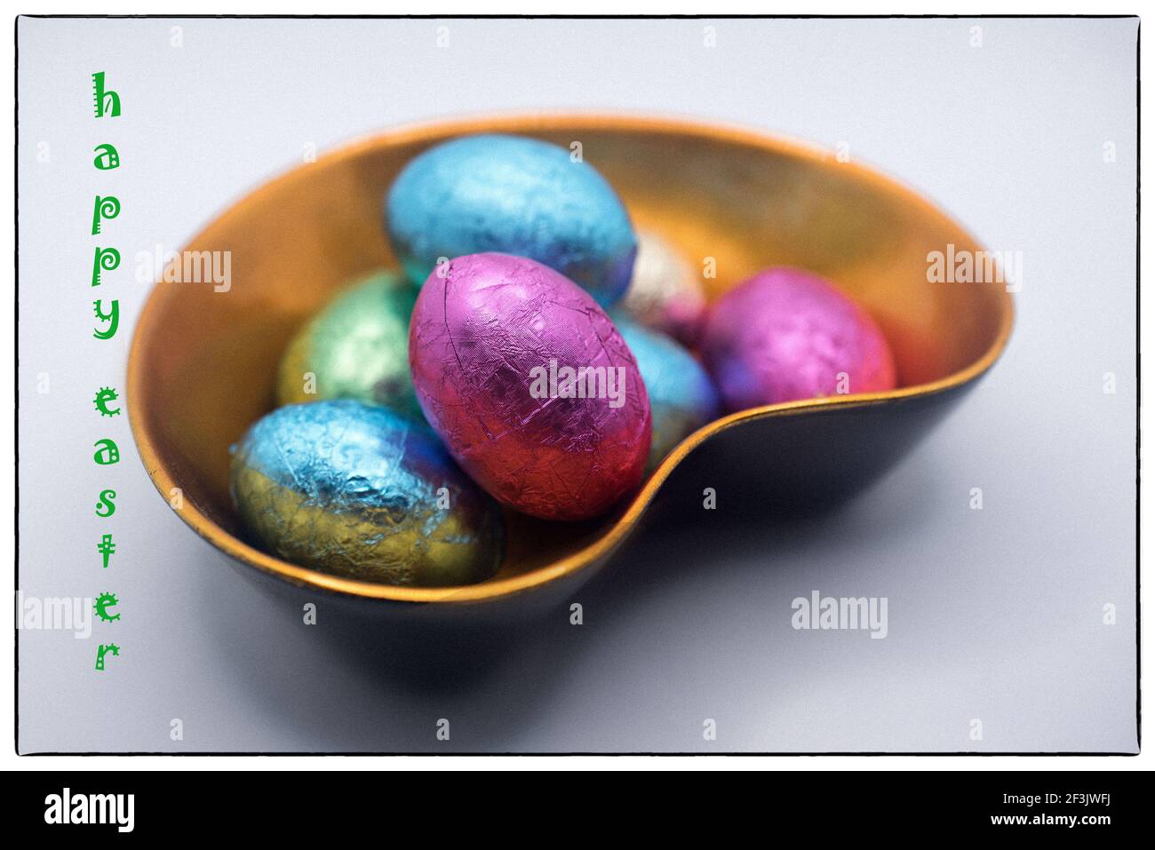 Easter chocolate eggs in the lacquer bowl with Happy Easter message Stock Photo