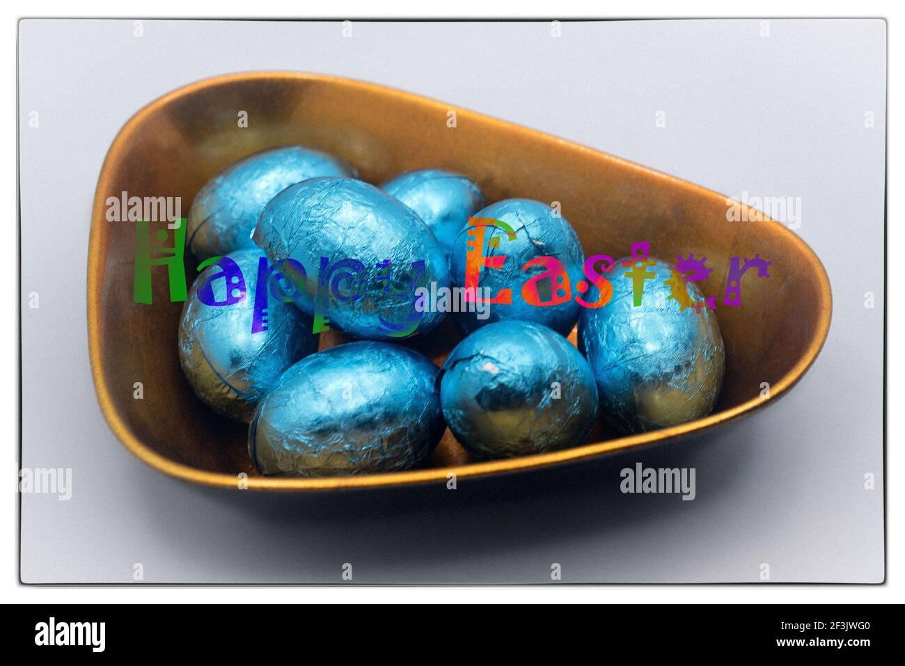 Easter chocolate eggs in the lacquer bowl with Happy Easter message Stock Photo