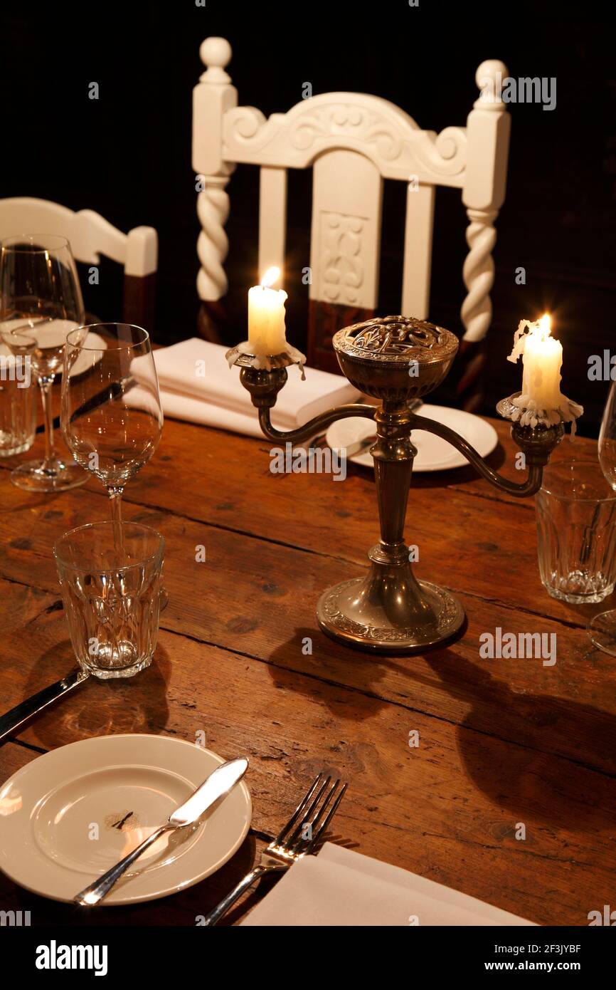 Dining table with silver candelabra and white painted jacobean style chair |  | Designer: Richard Brett / We Like Today Stock Photo