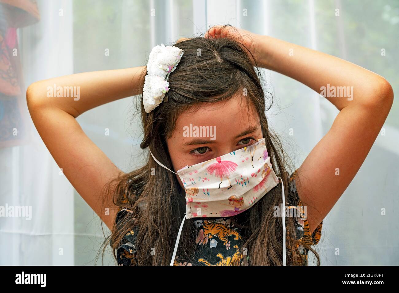 Young girl fitting homemade facemask Stock Photo