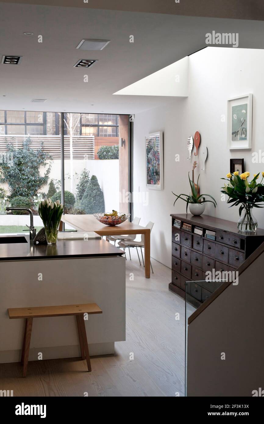 Modern open plan kitchen with island unit and dining area, Fulham town house, London Stock Photo