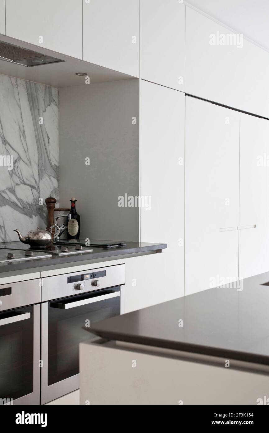 Detail of modern white kitchen with integral oven, Fulham Town House Stock Photo